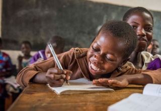 Child in Malawi learning in class