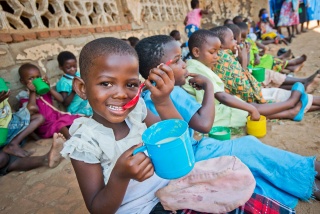 Child in Malawi eating porridge