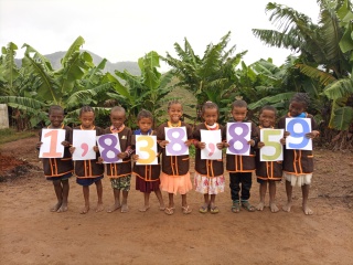 Children in Madagascar holding feeding figure