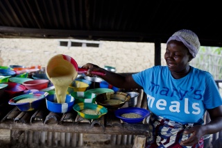 Volunteer serving food in Liberia