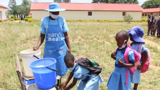 Cook serving Marys Meals