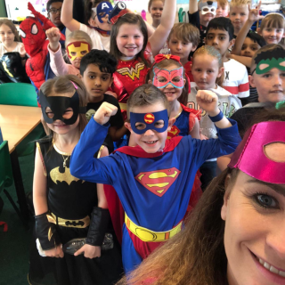 Primary pupils dressed in superhero costumes