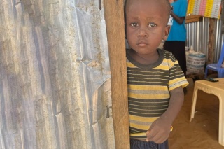 Early education learner in Lopwarin School standing at a door