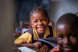 Child smiling in class, Liberia