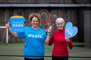 Judy Murray and Head of Supporter Care for Mary's Meals with tennis rackets and cardboard cut out of a love heart and a porridge mug