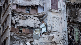 Kitchen cupboards visible within destroyed apartments from earthquake in Syria