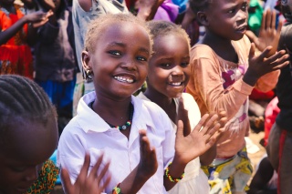 Children in Kenya smiling and clapping along