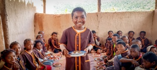 Child in Madagsacar receiving meals