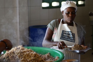 cook serving food in Haiti