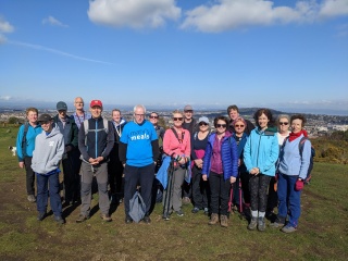 Supporters getting photographed on top of Easter Craiglockhart Hill Edinburgh while wearing blue Mary's Meals t-shirts