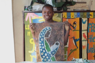 Image of child in Malawi with their painting 