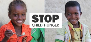 Children from Ethiopia smiling after receiving their food.