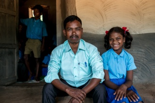 Sushila and her teacher sit outside class