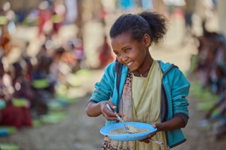A child eating from a bowl in Ethiopia