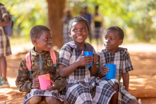 Image of three children eating their school meal