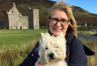 A lady, Alison, holding her pet dog