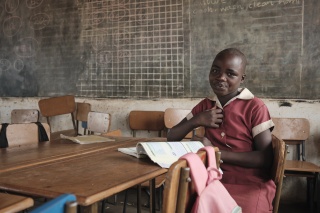 A young girl, Grace, sits in a classroom