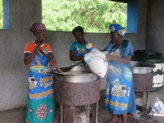 Three volunteer cooks cooking in Zambia
