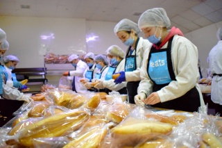 A group of people around a table preparing food in Syria