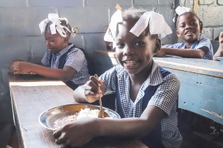 Image of a child eating food in Haiti
