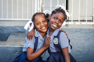 Image of two children happy having received their school meal
