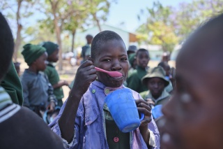 Boy eating in Zimbabwe