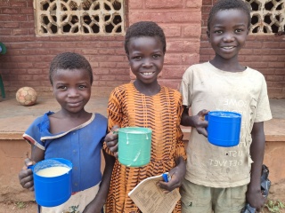 Dija, Mbilire and Lax with their first serving of Mary’s Meals