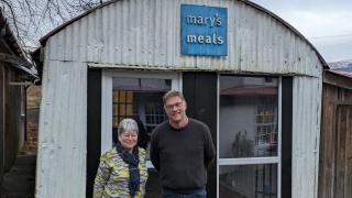 Julie Ramsay, Inner Wheel, with Mary's Meals Founder, Magnus MacFarlane-Barrow at the shed in Dalmally.