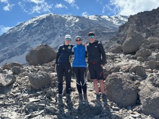 Two teenage boys and their mum pose happily on Kilimanjaro
