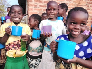 Children with mugs, Malawi