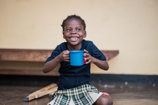 Image of a child in Malawi holding their school meal