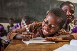 Image of a child enjoying learning in class