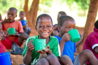 Image of children enjoying a meal at school in Malawi