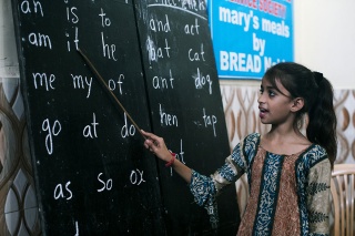 Image of a child in India learning in class