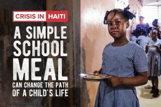 An image of a child receiving thier school meal in Haiti