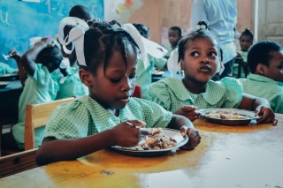 Girls in Haiti eating food together