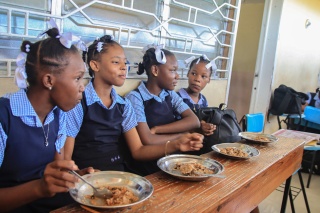 Girls in Haiti eating food together