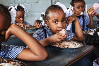 Children eating in the classroom in Haiti