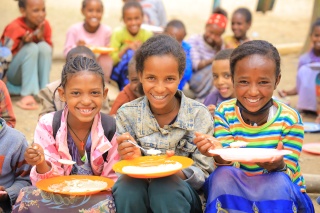 Girls in Ethiopia eating Mary's Meals