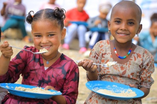 An image of children in Ethiopia enjoying their school meal