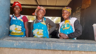Three volunteer cooks standing together