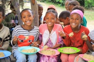 Girls eating in Ethiopia