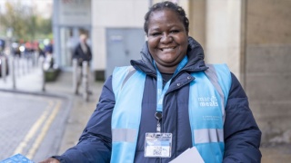 An image of a Marys Meals Volunteer handing out fliers