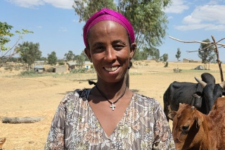 An image of Kidan, with the landscape of Ethiopia behind them