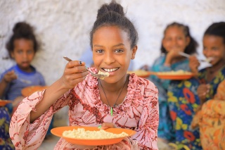 An image of a child in Ethiopia eating their Mary's Meals