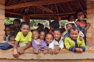 An image of children in Madagascar in school waiting for their school meal