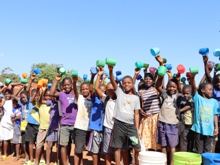 Children with their cups of porridge