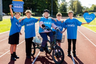 An image of a group of Mary's Meals fundraisers on a running track