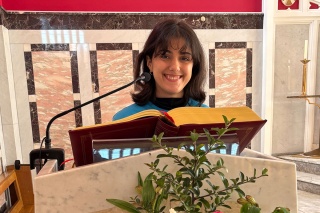 An image of a Mary's Melas supporter giving a talk in a church