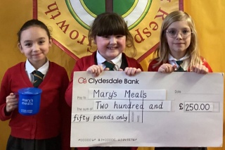 An image of children holding up a large cheque for Mary's Meals